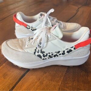 Nike Women's White Sneakers with Leopard Swoosh and Orange Accents
